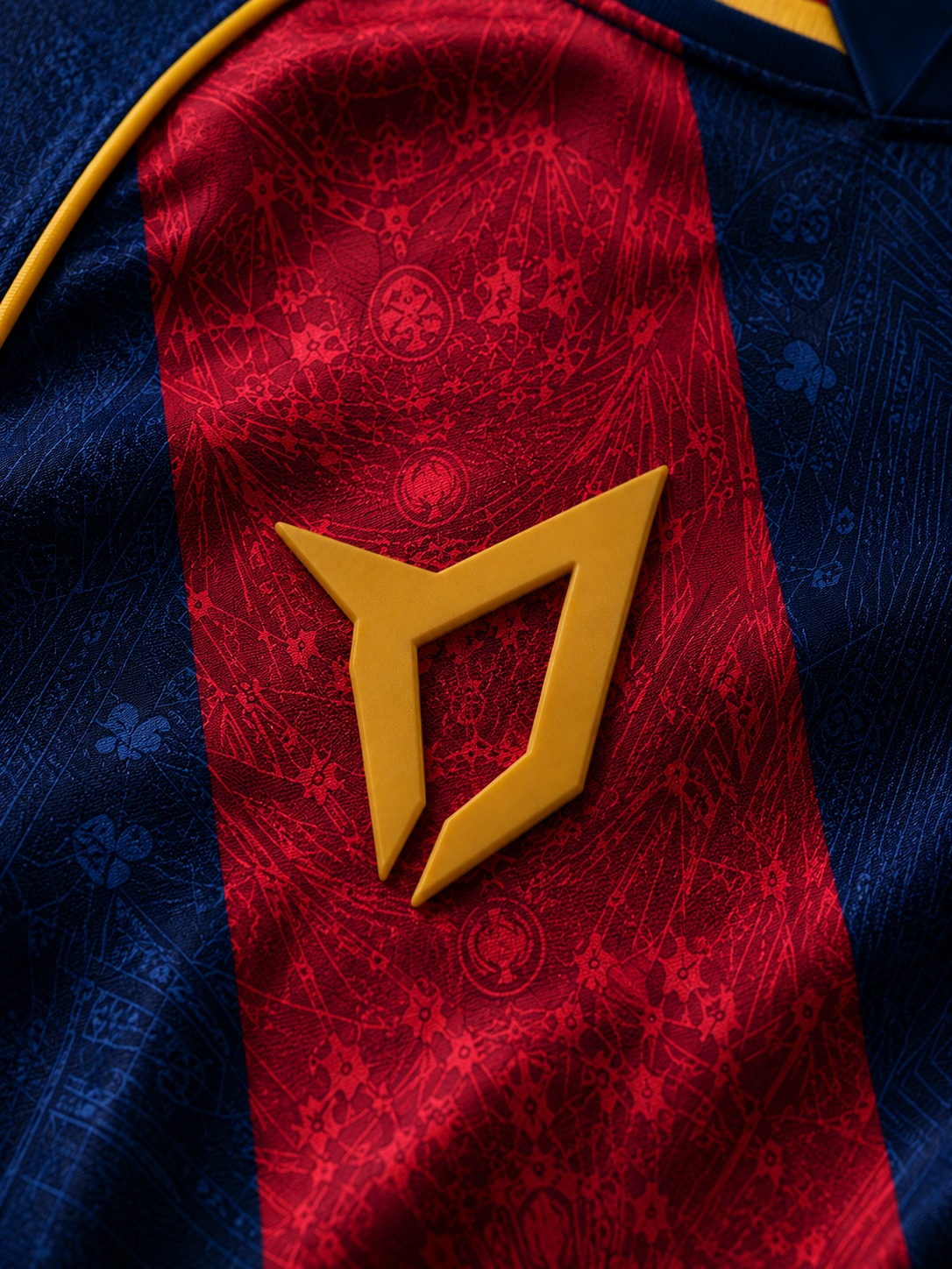 Close-up of the gold CATEN8 mark on the La Sagrada jersey