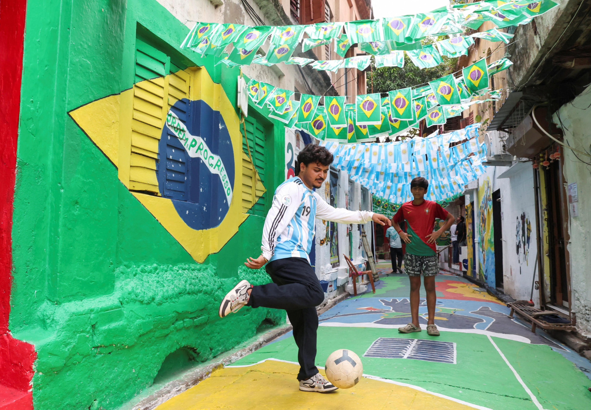 Colourful narrow lane with Brazil and Argentina flags hanging overhead